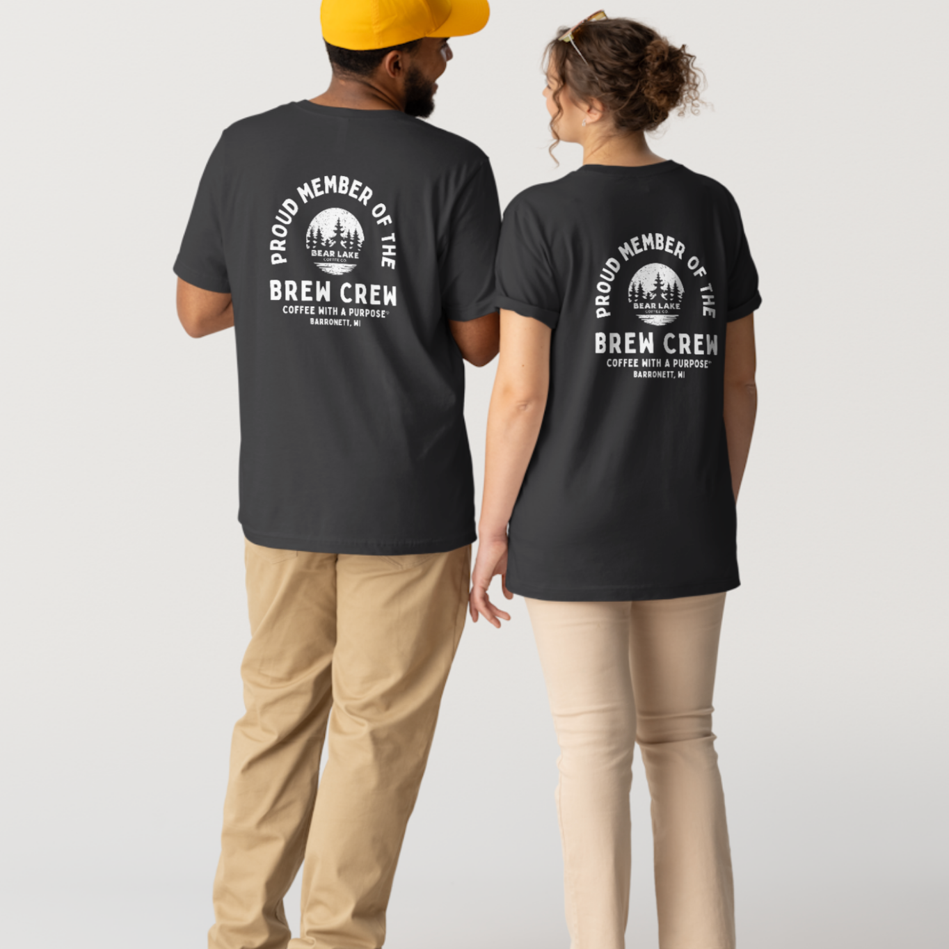 Couple wearing matching black Brew Crew t-shirts