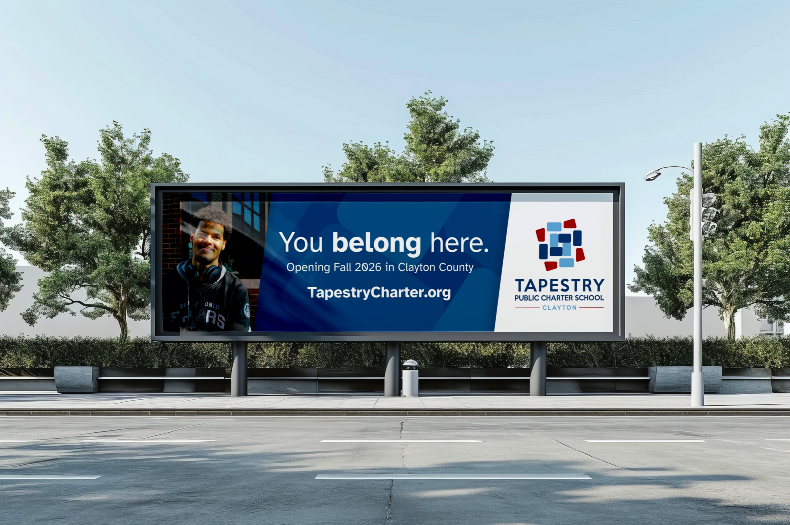 Billboard advertising Tapestry Public Charter School opening in Clayton