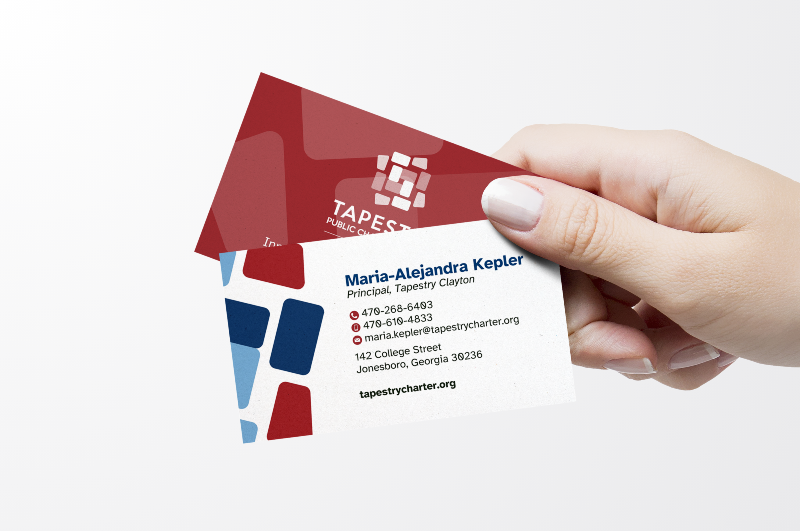 Hand holding Tapestry Public Charter school business cards