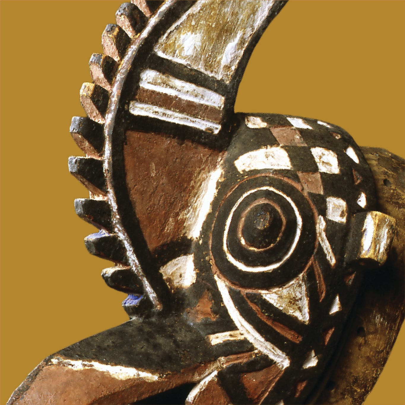 Carved wooden African mask with geometric patterns
